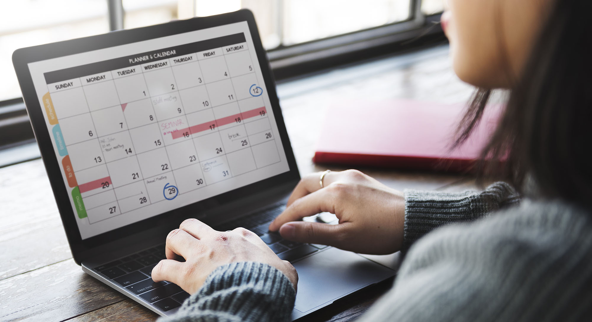 Woman using laptop to view a calendar application